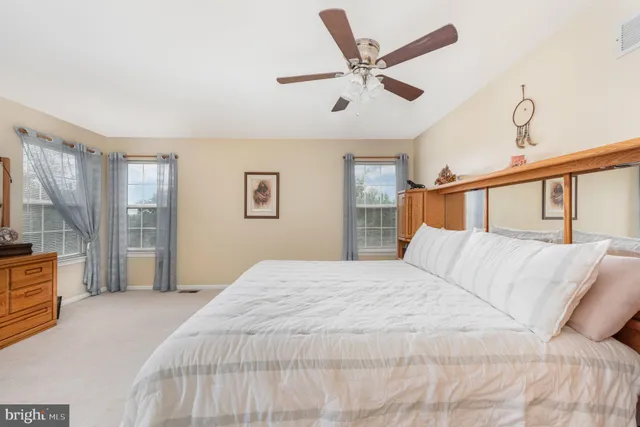 a spacious bedroom with a bed and a chandelier