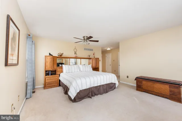 a bedroom with a bed and a view of living room
