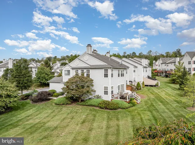 a living room with furniture and floor to ceiling windows