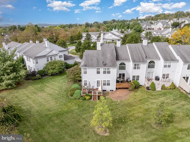 a living room with furniture gym equipment and a large window