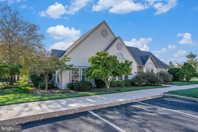 a view of a house with pool and chairs