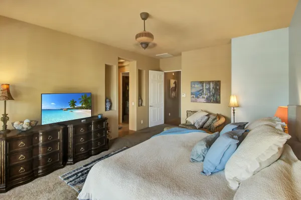 a bedroom with a bed and a dresser