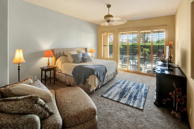 a bedroom with two beds and a large window