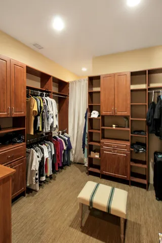 a bedroom with bed and a closet