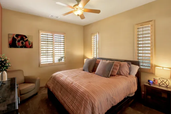 a bedroom with bed and a couch