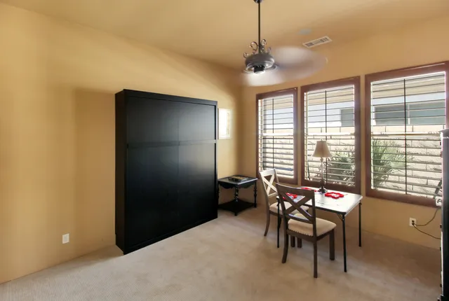 a patio with a table and chairs