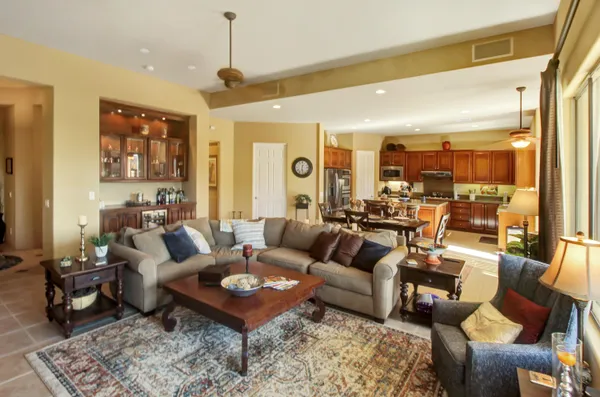 a living room with furniture potted plant and a large window