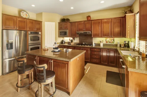 a kitchen with a sink appliances and cabinets
