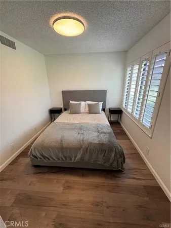 a bedroom with a bed and a large window