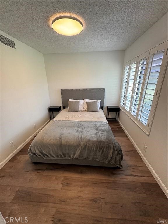 69520 Huerta Court Rancho Mirage, CA 92270 - Photo 12 of 25 a bedroom with a bed and a large window