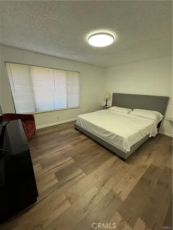 a bedroom with a bed and a night stand