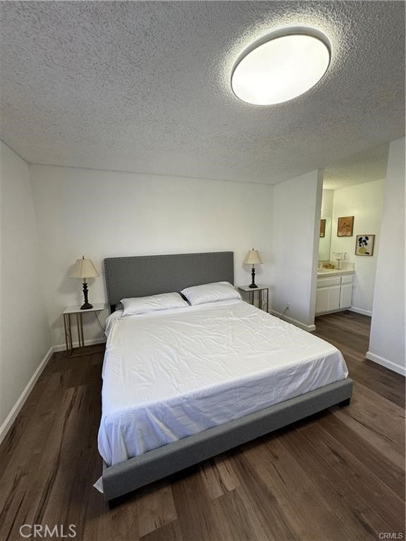 69520 Huerta Court Rancho Mirage, CA 92270 - Photo 15 of 25 a bedroom with a bed and a chandelier