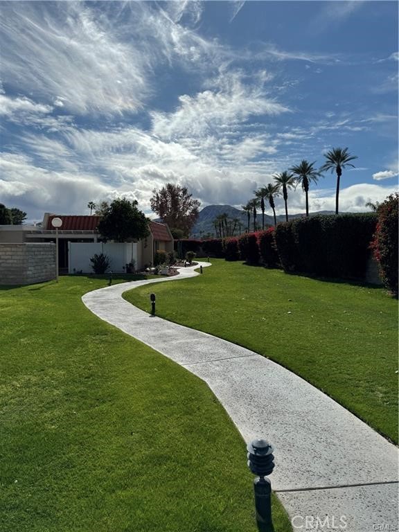 69520 Huerta Court Rancho Mirage, CA 92270 - Photo 22 of 25 a view of a swimming pool with a yard