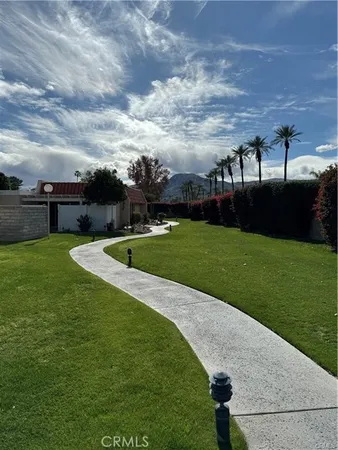 a view of a swimming pool with a yard