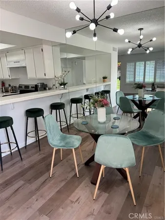 a kitchen with a dining table chairs and view kitchen