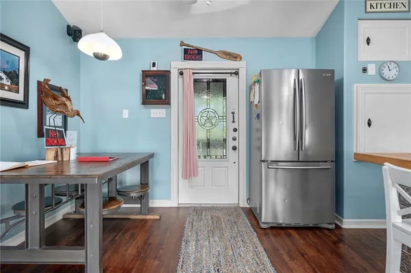 a kitchen with stainless steel appliances granite countertop a refrigerator a stove and a wooden floors