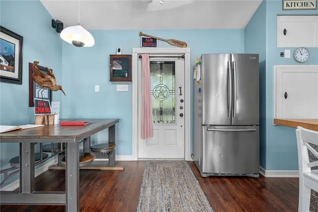 a kitchen with stainless steel appliances granite countertop a refrigerator a stove and a wooden floors