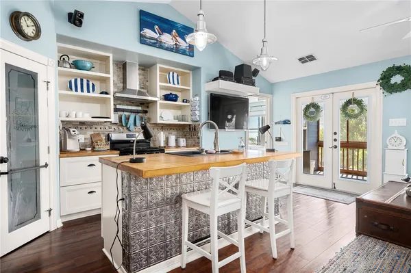 a dining room with stainless steel appliances granite countertop a dining table and chairs