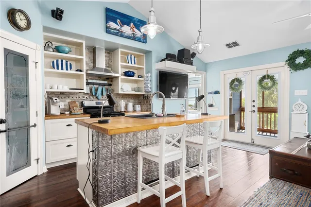 a dining room with stainless steel appliances granite countertop a dining table and chairs