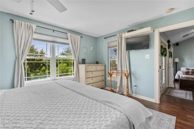 a bedroom with a bed and large window