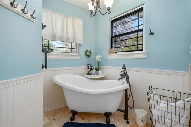 a en suite bathroom with a granite countertop sink and a mirror