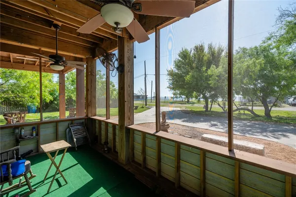 a view of a porch with chairs and backyard