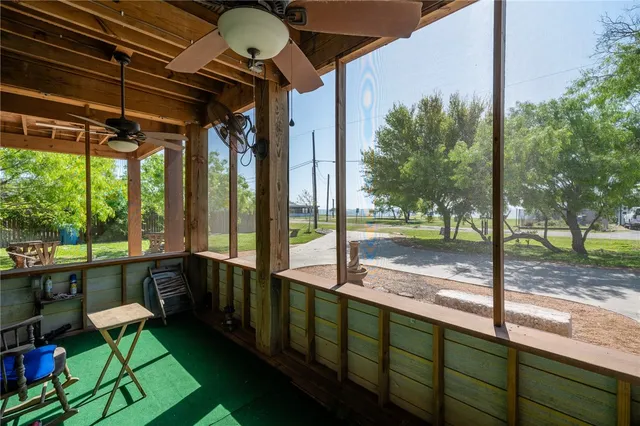 a view of a porch with chairs and backyard