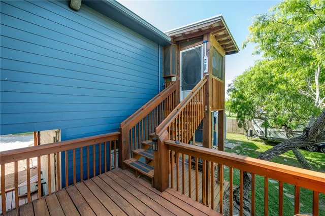 a view of deck with wooden floor and fence and a floor to ceiling window