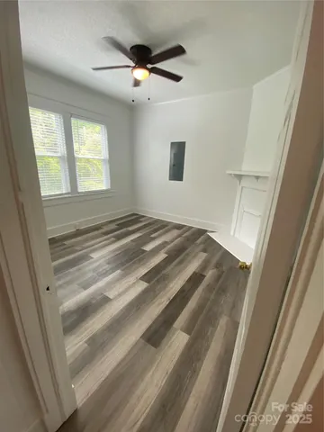 a view of a room with wooden floor