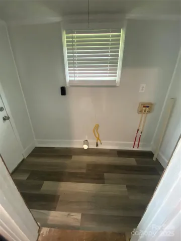 a view of a room with an empty space and a window