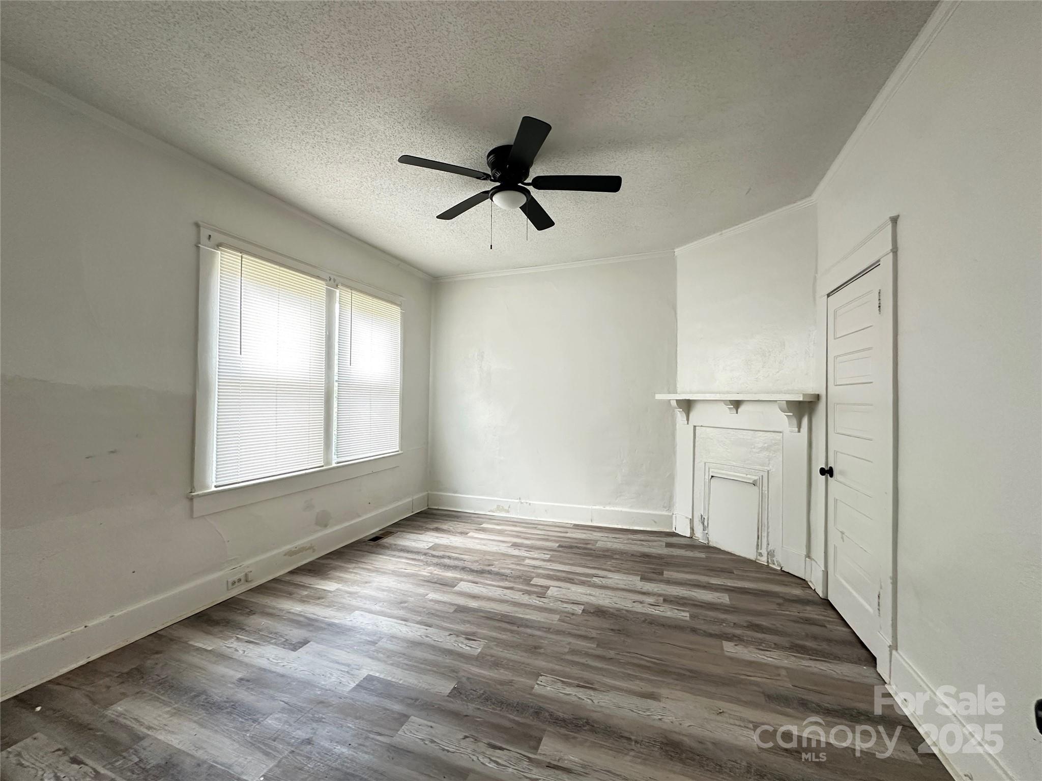 140 8th Street Winnsboro, SC 29180 - Photo 8 of 19 wooden floor in an empty room with a window