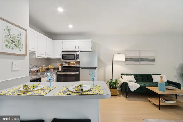 a kitchen with a refrigerator and a stove top oven