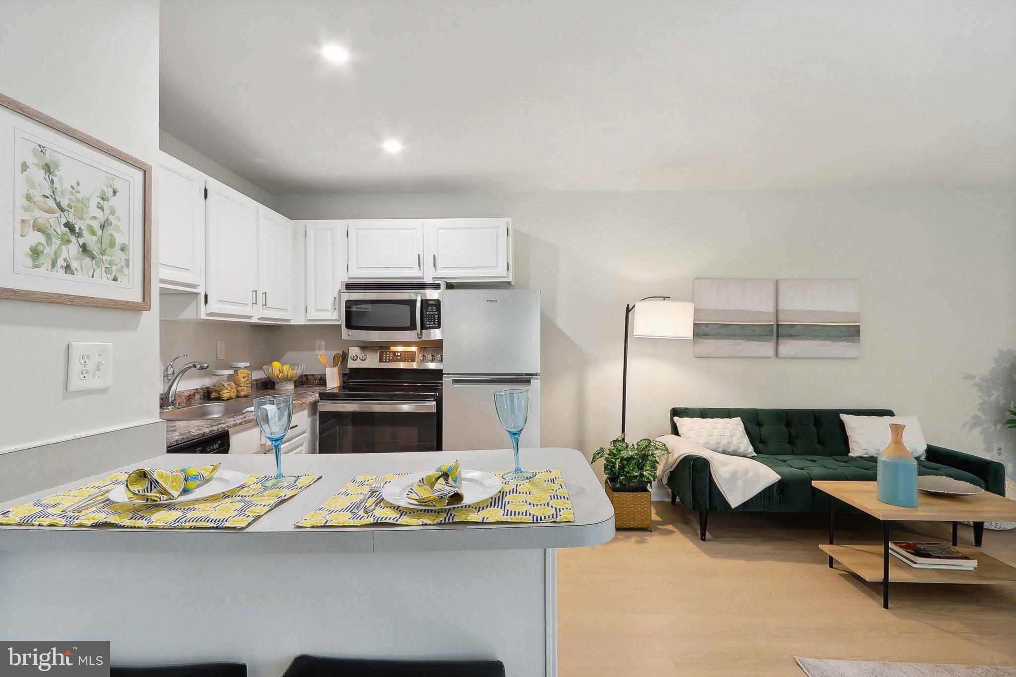 a kitchen with a refrigerator and a stove top oven