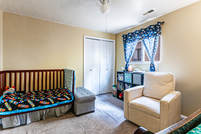 947 Canyon Road, Unit 33 Ogden, UT 84404 - Photo 10 of 19 Carpeted room featuring neutral wall tones, a window with horizontal blinds, and a ceiling fan with integrated lighting