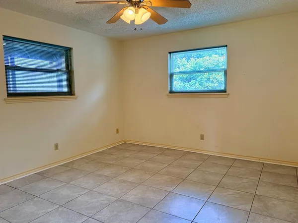 an empty room with a fan