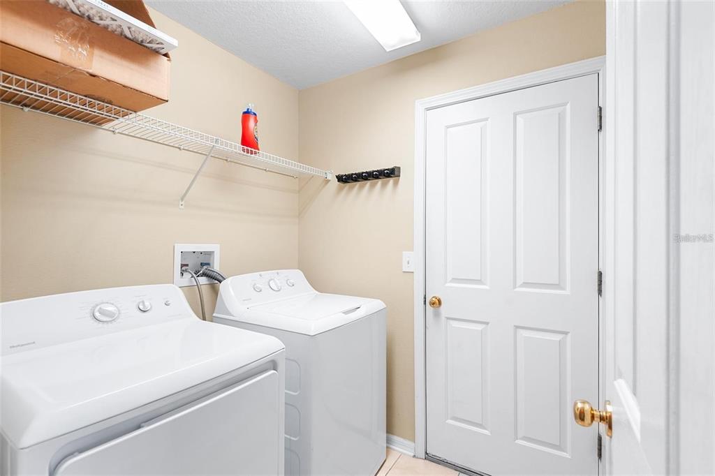 3483 Beaumont Loop Spring Hill, FL 34609 - Photo 12 of 14 a utility room with dryer and washer