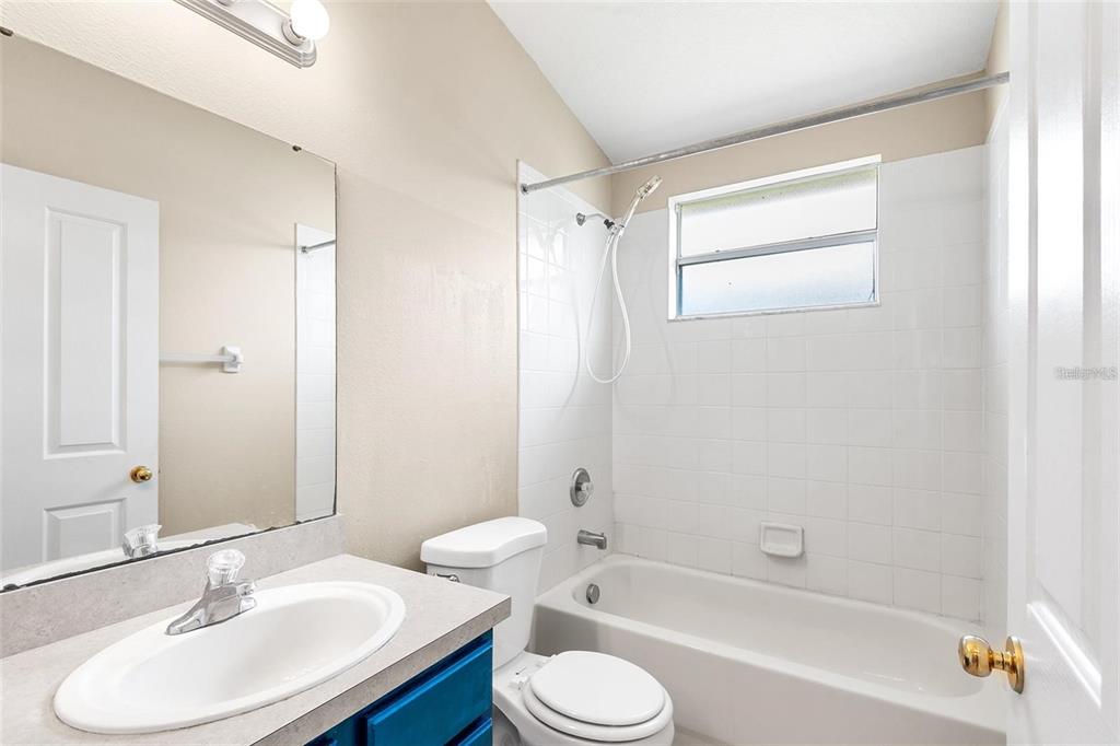 3483 Beaumont Loop Spring Hill, FL 34609 - Photo 10 of 14 a bathroom with a sink toilet and shower