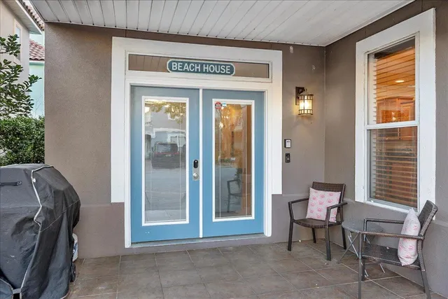 a view of front door with furniture and a window