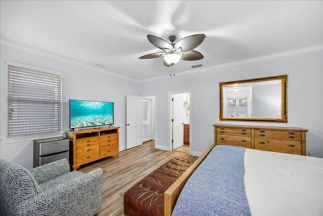 a bedroom with furniture and a flat screen tv