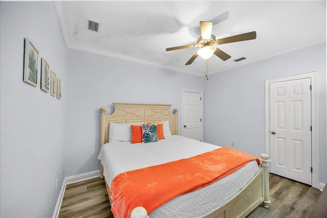 a bedroom with a bed and wooden floor