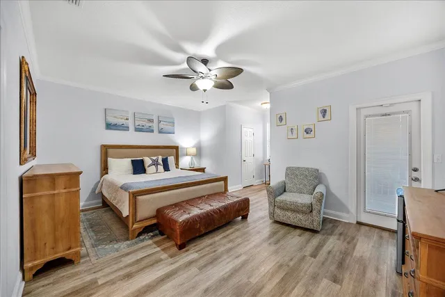 a bedroom with furniture and a wooden floor
