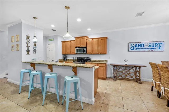 a large kitchen with stainless steel appliances granite countertop a stove and a sink