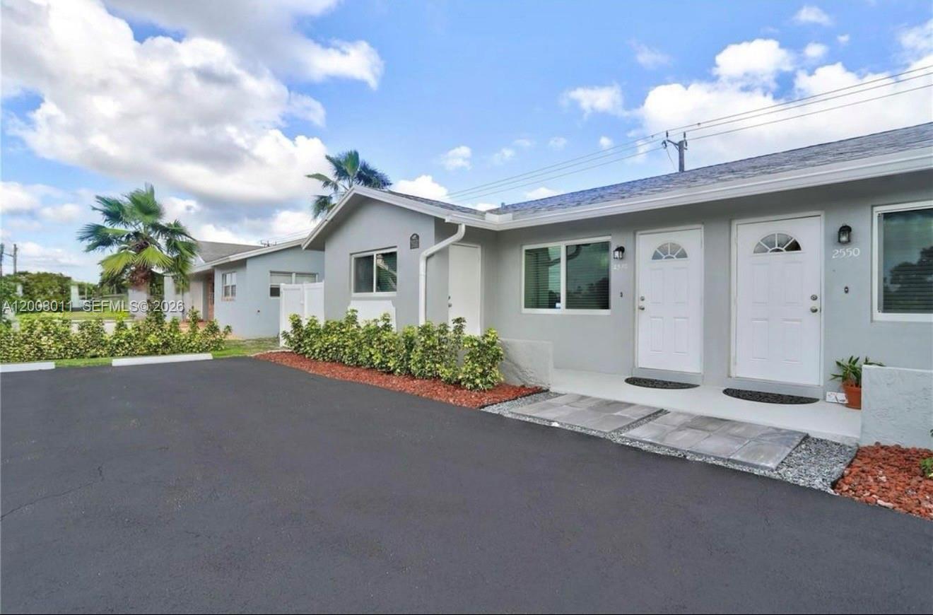 2550 North Dixie Highway, Unit 2570 Boca Raton, FL 33431 - Photo 16 of 16 a view of a house with a street and a garage