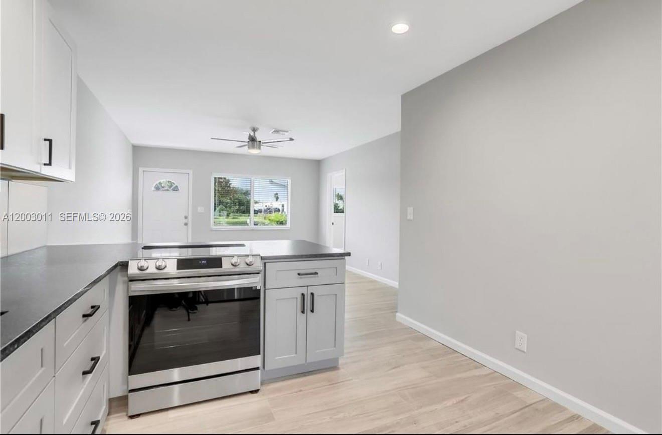 2550 North Dixie Highway, Unit 2570 Boca Raton, FL 33431 - Photo 3 of 16 a kitchen with a stove and a sink