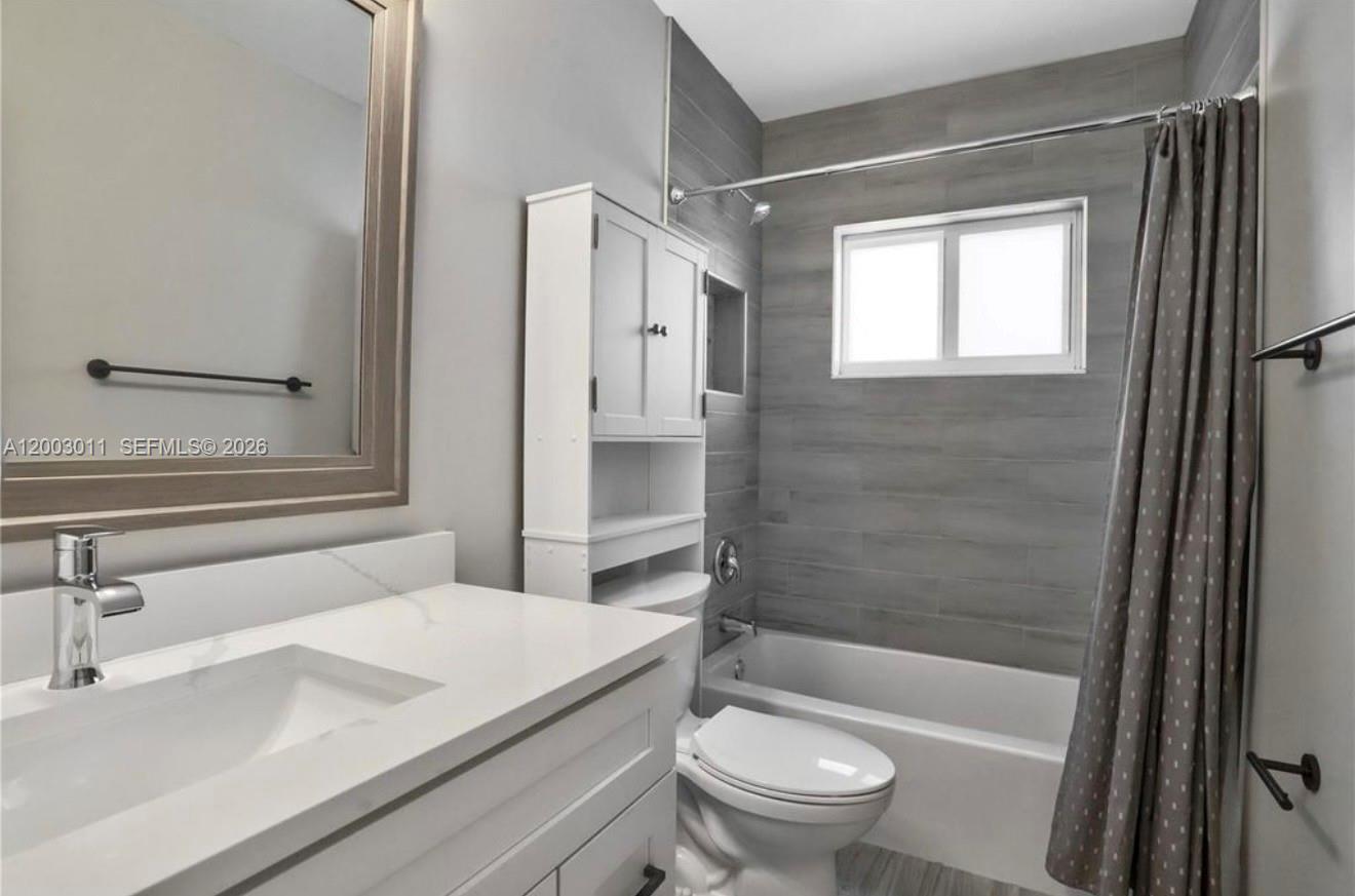 2550 North Dixie Highway, Unit 2570 Boca Raton, FL 33431 - Photo 7 of 16 a bathroom with a sink a toilet and shower