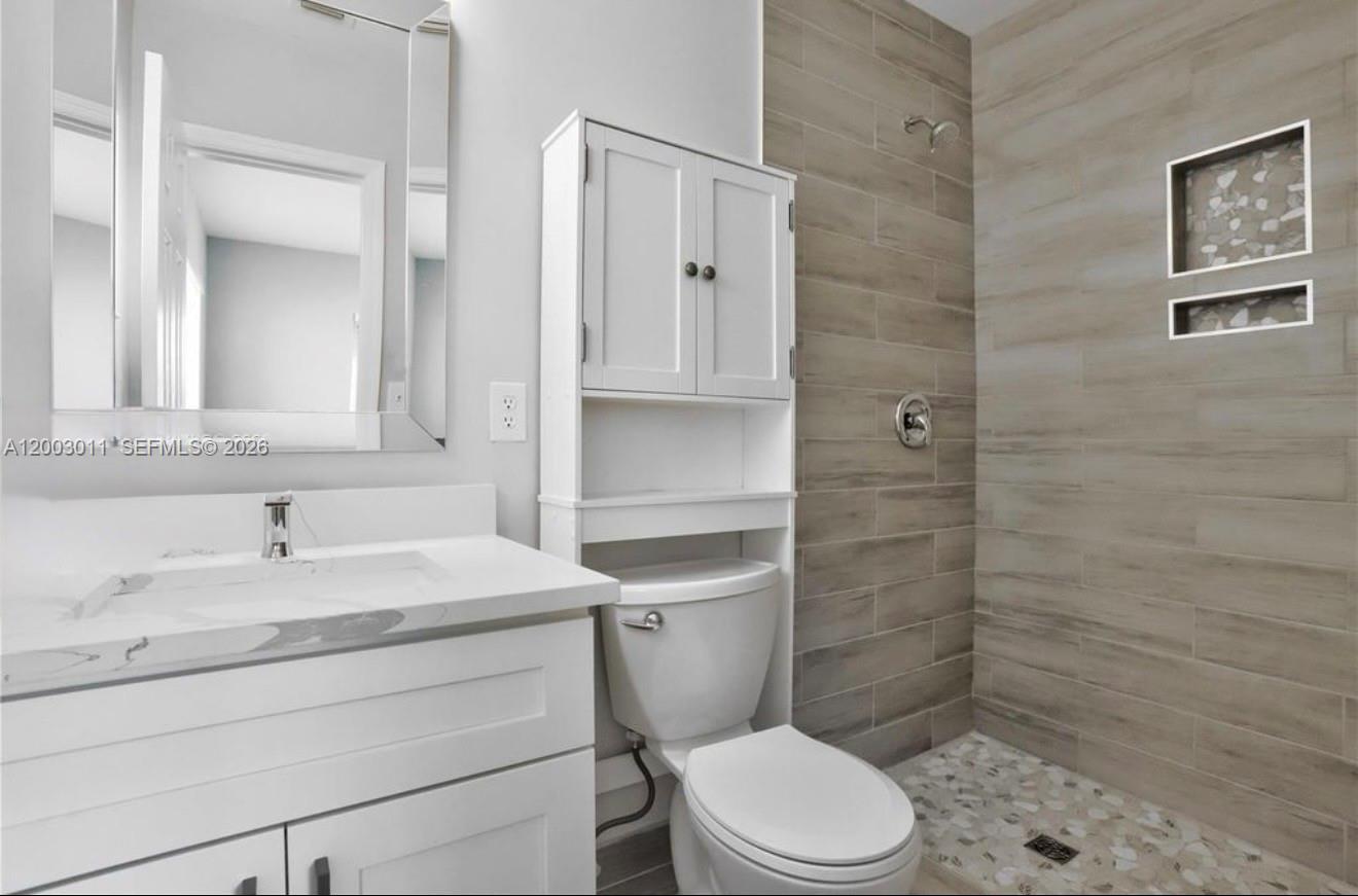 2550 North Dixie Highway, Unit 2570 Boca Raton, FL 33431 - Photo 10 of 16 a bathroom with a sink a toilet and shower