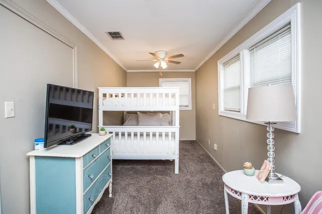 a room that has a bed and a table in it