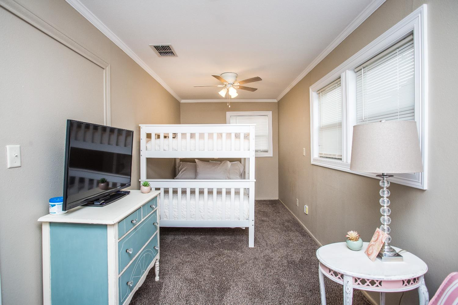 2418 23rd Street Lubbock, TX 79411 - Photo 12 of 17 a room that has a bed and a table in it