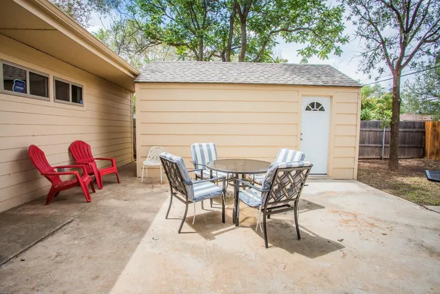 a view of a backyard with table and chairs