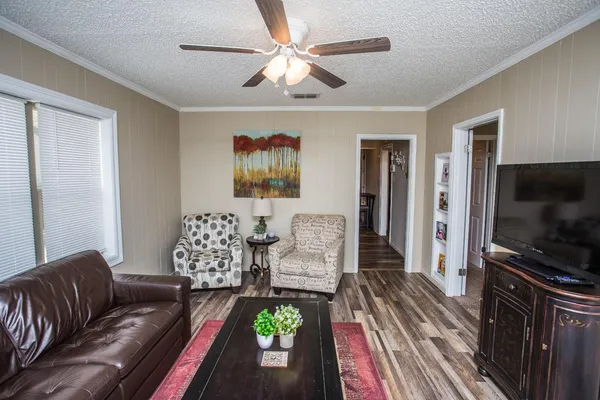 a living room with furniture and a flat screen tv